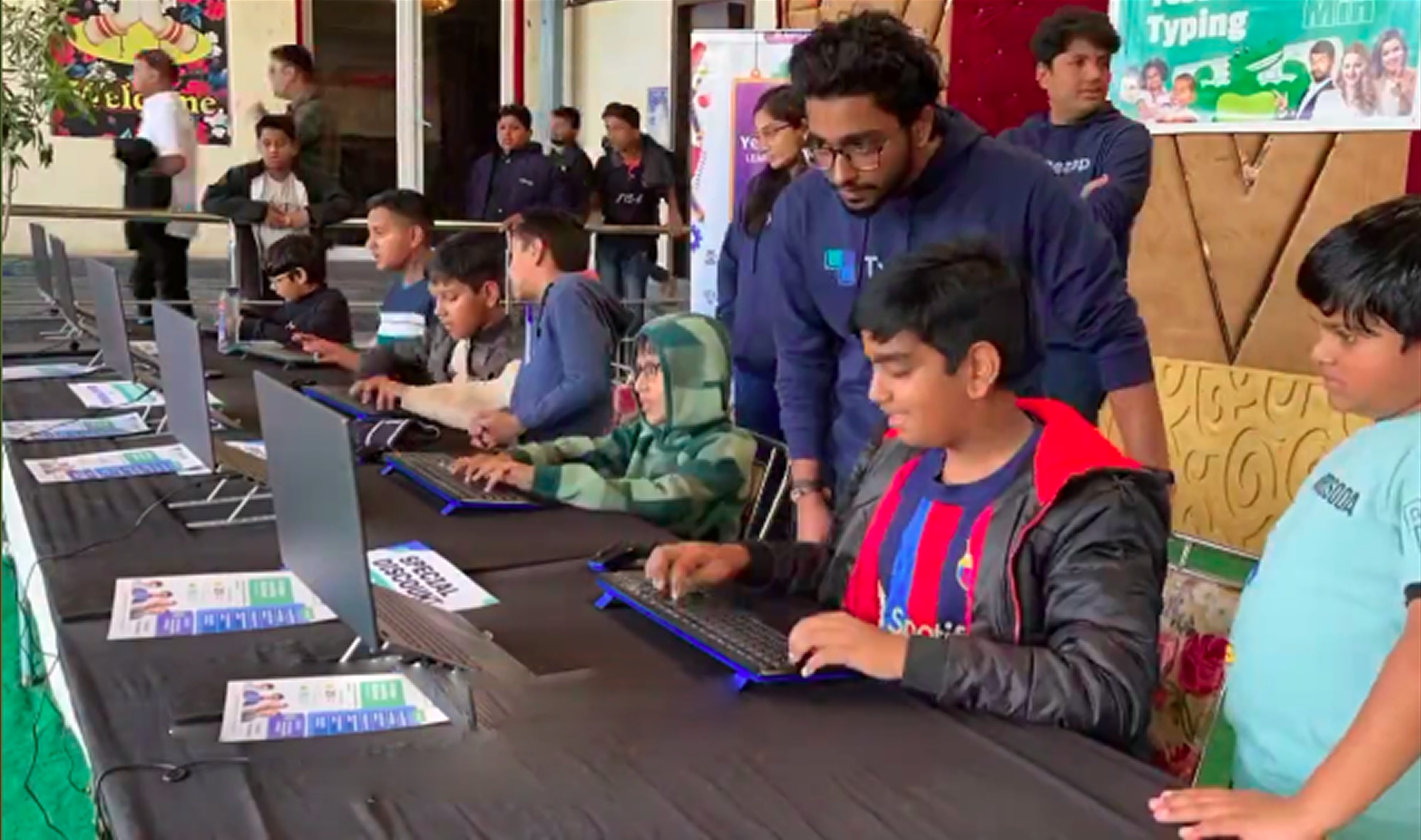 Testing session at schools and public events - children actively typing on computers
